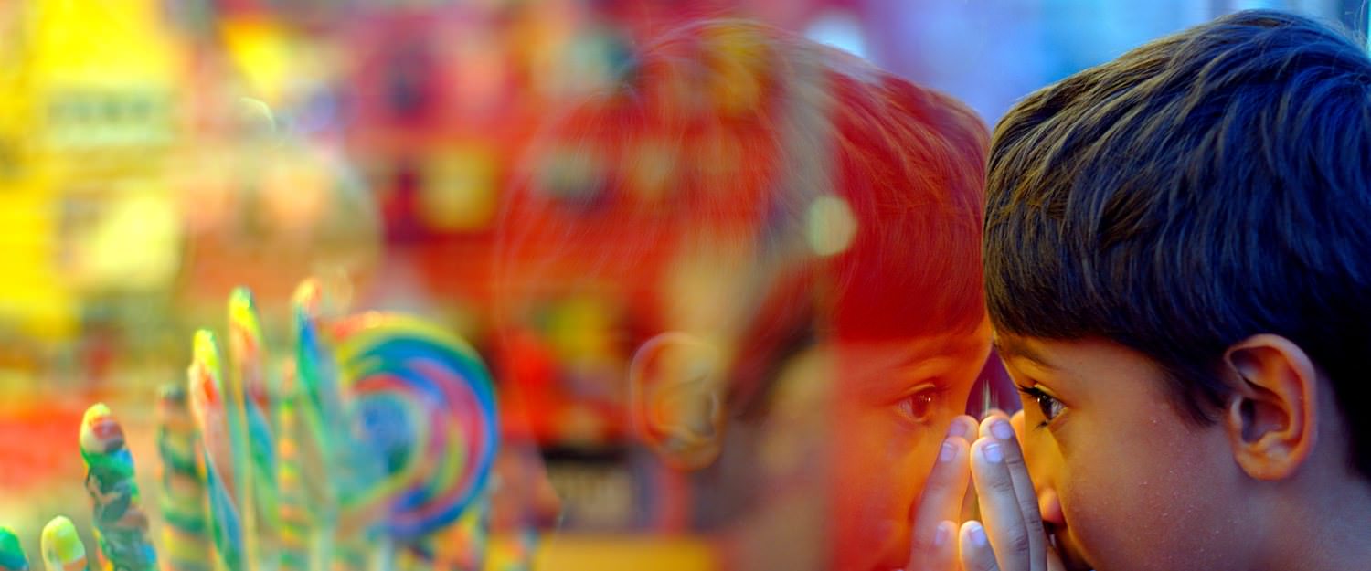 Children on a windows with candy